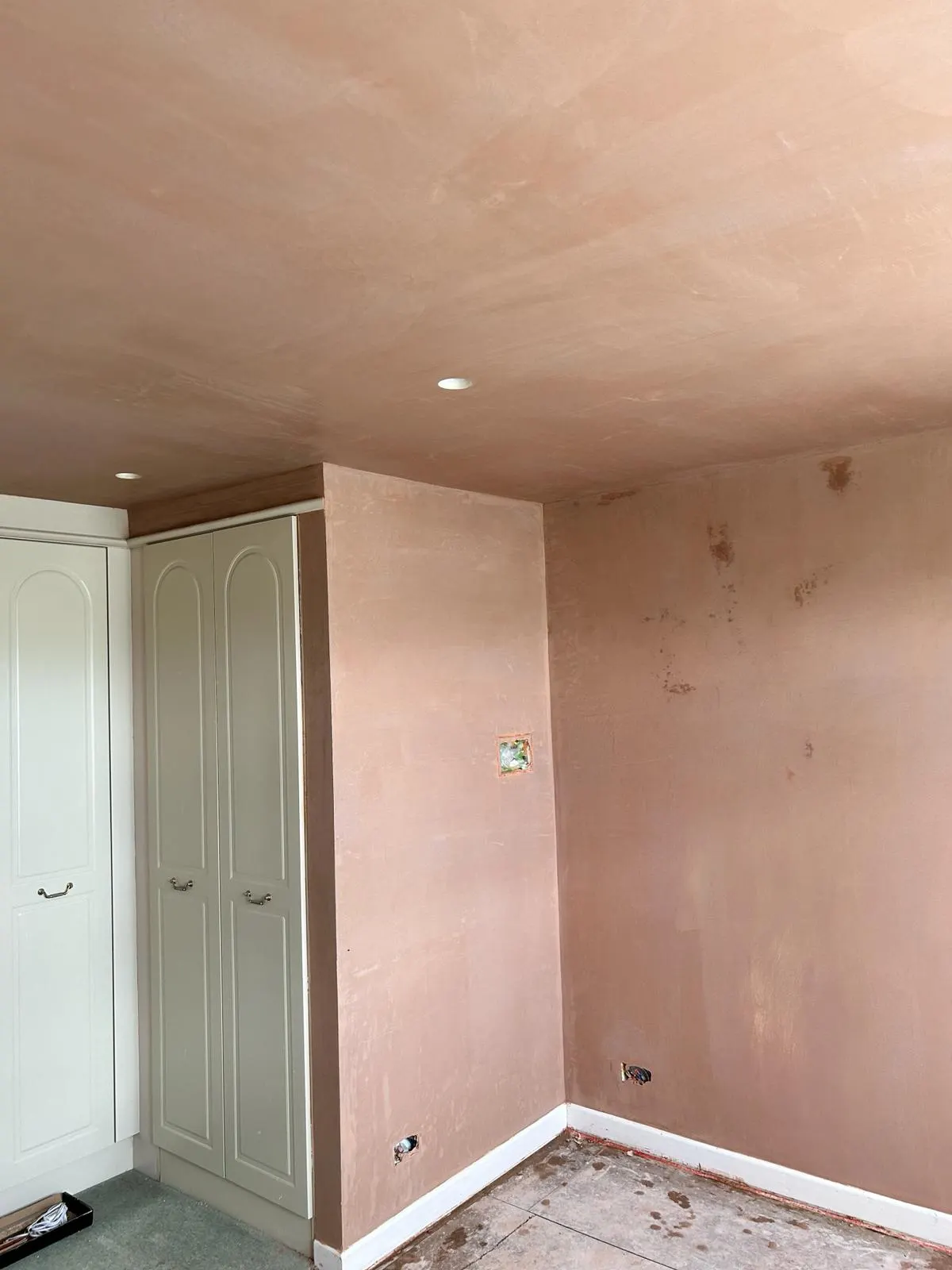 Freshly skimmed ceiling and wall beside fitted bedroom wardrobes