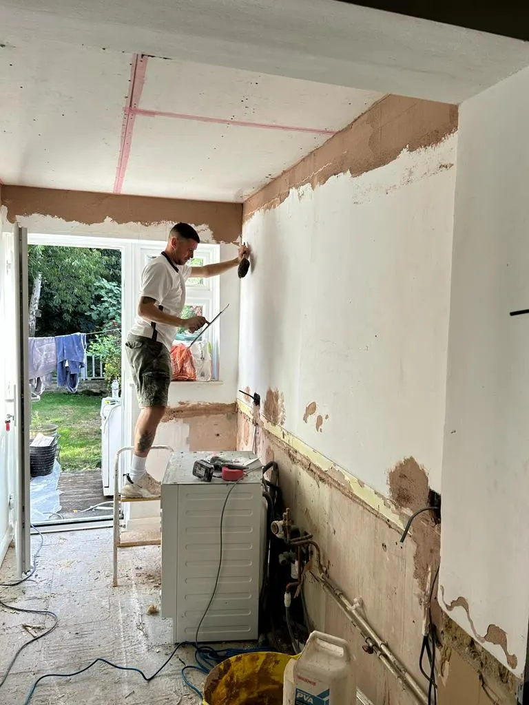 Hancock plasterer re-skimming a kitchen wall during a full renovation