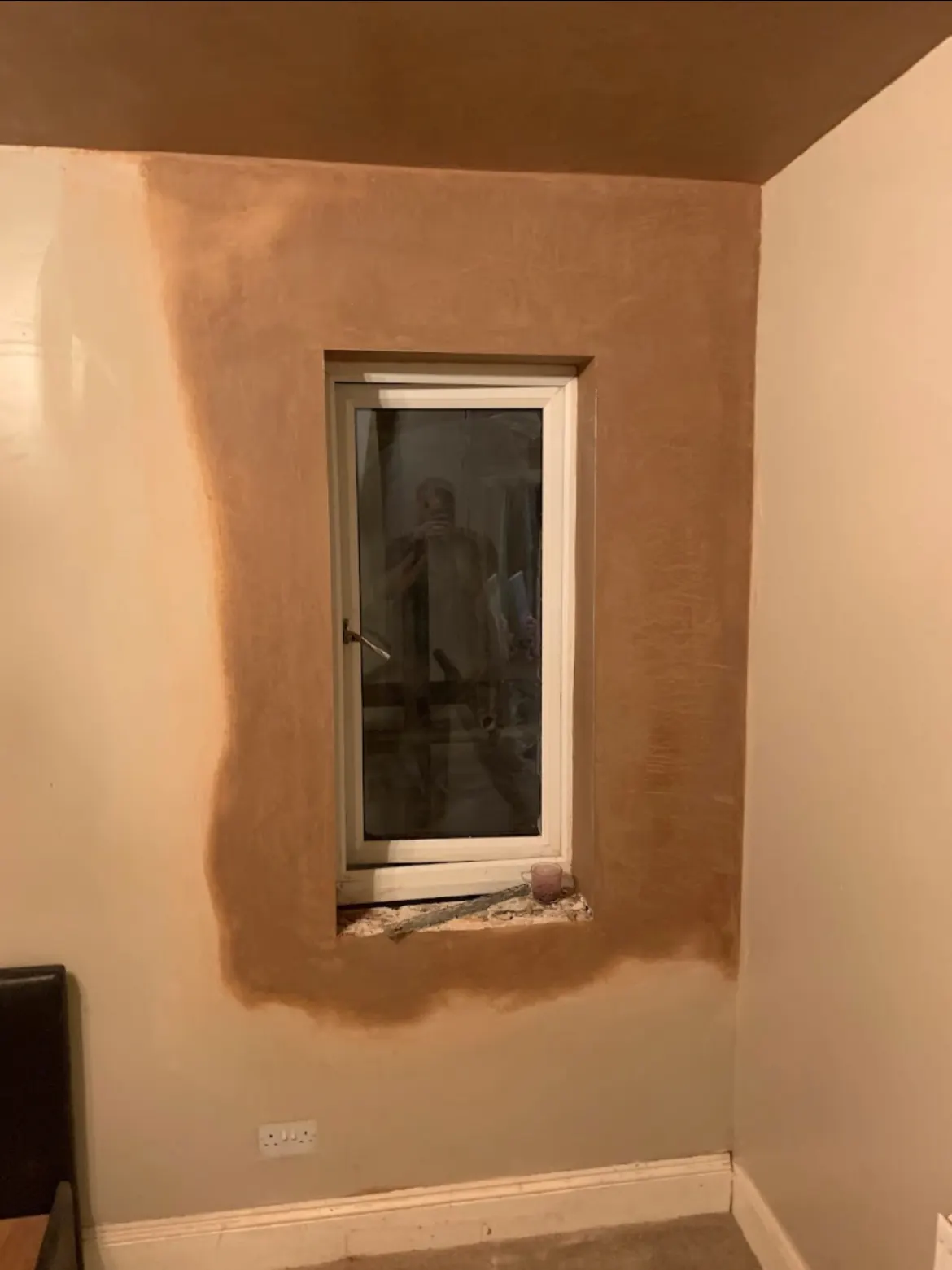 Neatly plastered window reveal with a crisp, smooth skim finish