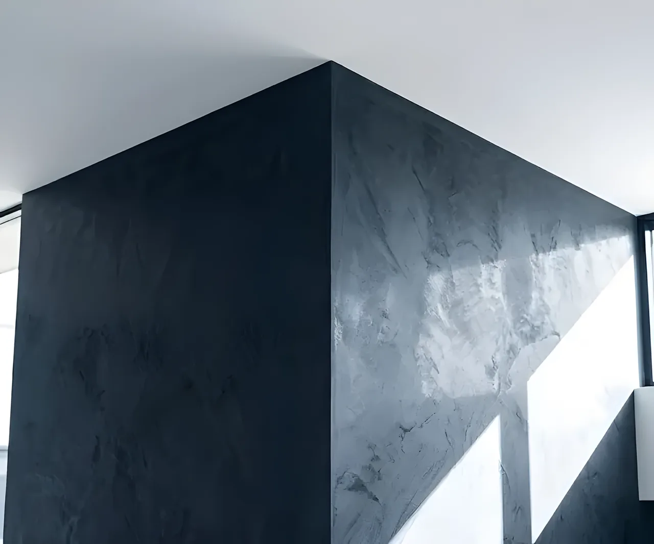Polished dark Venetian plaster wall catching the light
